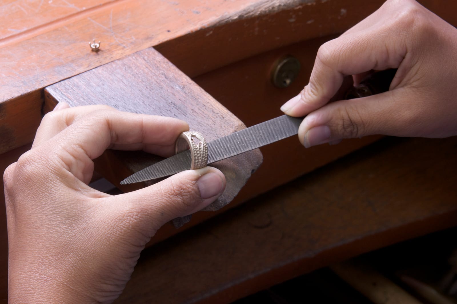 A set band is filed by hand at the bench.